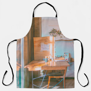 BROWN WOODEN TABLE WITH WHITE PRINTER PAPER APRON