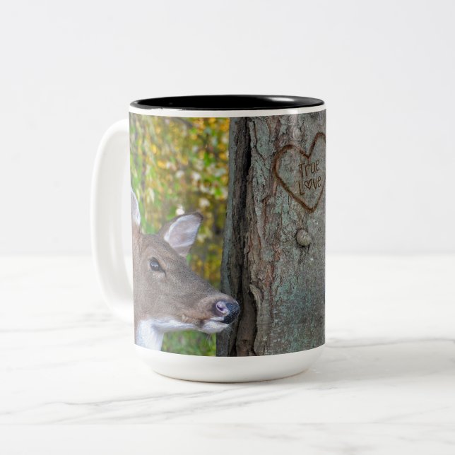 buck and doe with heart on tree Two-Tone coffee mug (Front Left)