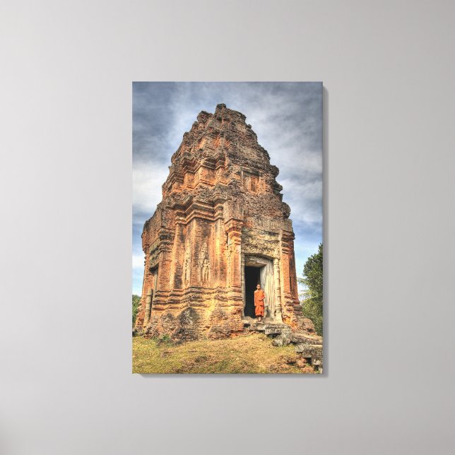 Buddhist monk standing in doorway of temple canvas print (Front)