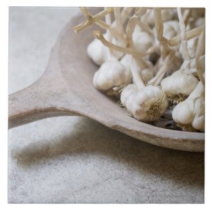 Bulbs of garlic in an earthenware bowl tile
