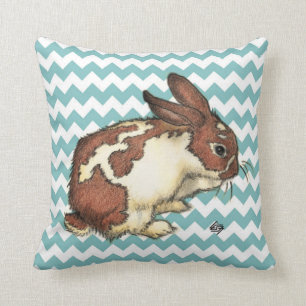 Bunny washing his face with blue chevron cushion