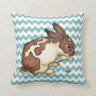 Bunny washing his face with blue chevron cushion