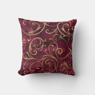 Burgundy and gold filigree print cushion