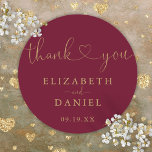 Burgundy Gold Heart Script Thank You Wedding Favou Classic Round Sticker<br><div class="desc">Elegant burgundy and gold heart script thank you sticker personalised with your names and special date. Designed by Thisisnotme©</div>