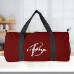 Burgundy Grey White Script Monogram  Duffle Bag<br><div class="desc">This personalised duffel bag features a monogram and first name in modern grey and white script on a stylish burgundy red background.</div>