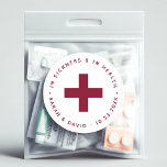Burgundy Hangover Kit In Sickness and in Health  Classic Round Sticker<br><div class="desc">A sticker for the Emergency Kit (aka Hangover Kit) to put in a destination wedding welcome bag, with some medicine inside. Recommended for a wedding that has burgundy as wedding colour. It has a burgundy cross in the centre and arched text making a circle around it. Above it, there is...</div>
