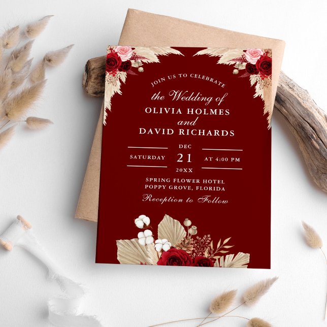 Burgundy Roses and Pampas Grass Wedding Invitation (Burgundy Roses and Pampas Grass Wedding Invitation on a table surrounded with pampas grass.)