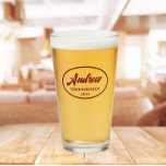 Burgundy Stylised Wedding Groomsman Name Glass<br><div class="desc">Beer glass for the wedding groomsman that features his name printed in a trendy burgundy, stylised script inside a burgundy colour oval border along with wedding date. A great party supply idea for a bachelor party! Personalise your beer glass by editing and replacing name and date with your own. Available...</div>