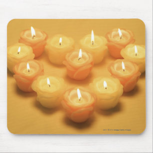 Burning candles arranged in a heart shape mouse mat