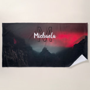 Burning clouds, fog and mountains monogram in sky beach towel