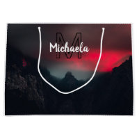 Burning clouds, fog and mountains monogram in sky