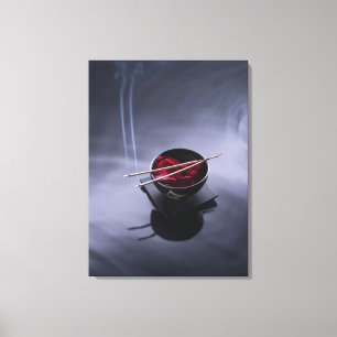 Burning incense on top of bowl of petals canvas print
