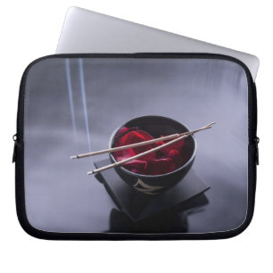Burning incense on top of bowl of petals laptop sleeve