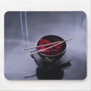 Burning incense on top of bowl of petals mouse mat