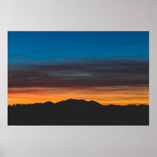 Burning sunset above landscape silhouette poster