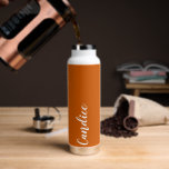 Burnt Orange Personalised Wedding Bridesmaid Water Bottle<br><div class="desc">Gift your bridesmaid or maid of honour with this trendy, vacuum Insulated water bottle that features her name in white, stylised script on a burnt orange colour background designed to match your wedding colour scheme. Personalise bottle by editing and replacing name with your own as desired. Select your water bottle...</div>
