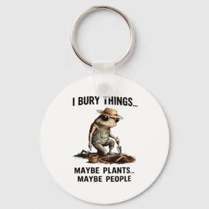 Bury things maybe plants maybe people funny frog key ring