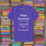 Business Hanukkah Greeting on Purple T-Shirt<br><div class="desc">Happy Hanukkah! Wishing you joy, peace and blessing this festival of lights. Holiday to celebrate this December and to advertise also your business. Purple t-shirt with Hanukkah greeting, your business name and logo. T-Shirt that you can include in your promotional products, giveaway items or gifts to your customers or clients...</div>