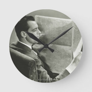 Businessman Reading the Newspaper Round Clock