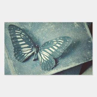 Butterfly on vintage books rectangular sticker