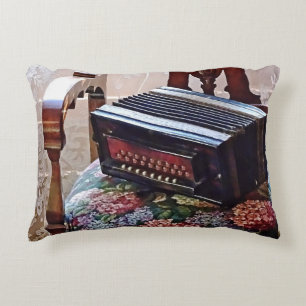 Button Accordion on Chair With Flowered Seat Decorative Cushion