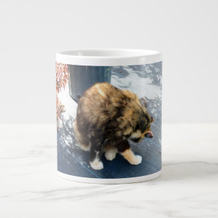 calico cat licking hind legs large coffee mug