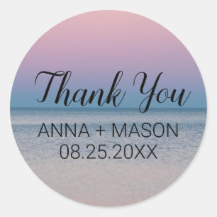 Calm sea under pastel sky classic round sticker