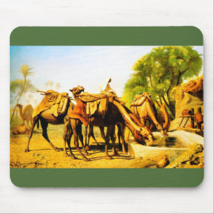 Camels drinking at an oasis mouse mat