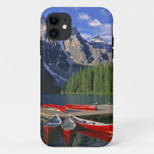 Canada, Alberta, Moraine Lake. Red canoes await iPhone 11 Case
