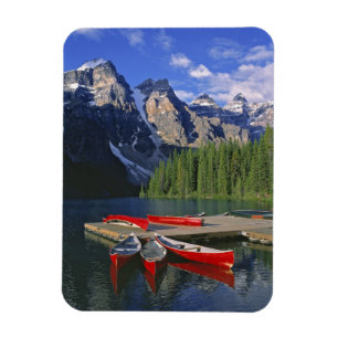 Canada, Alberta, Moraine Lake. Red canoes await Magnet