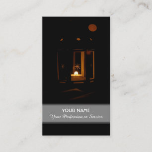 Candle light illuminates the dark business card