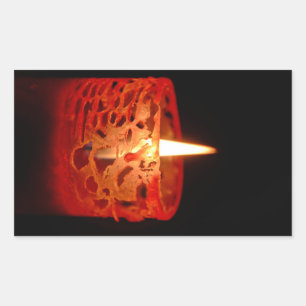 Candle on a black background rectangular sticker