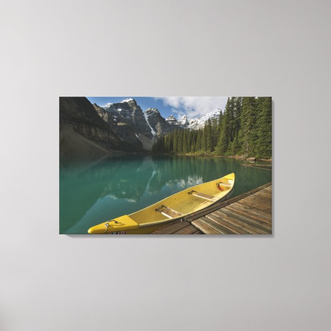 Canoe parked at a dock along Moraine Lake, Banff Canvas Print (Front)
