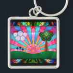 Canticle of the Sun Keychain<br><div class="desc">A digital stained-glass design in the Art Deco style popular in the 20th century. The widely-used sunburst motif is central, rising behind a green landscape balanced by a tree on one side and clouds and flowers on the other. Geometric shapes are used to emphasise the symmetry of the scene, with...</div>