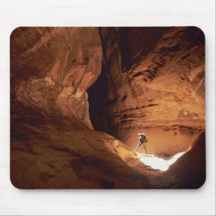 Canyoneer illuminated in the depths of a narrow mouse mat