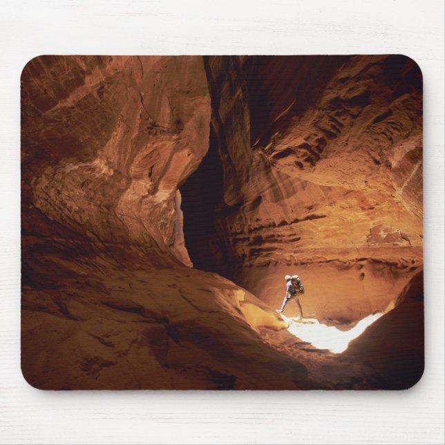 Canyoneer illuminated in the depths of a narrow mouse mat (Front)