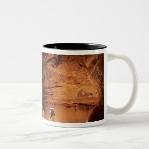 Canyoneer illuminated in the depths of a narrow Two-Tone coffee mug