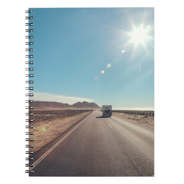 Car on black asphalt road notebook (Front)