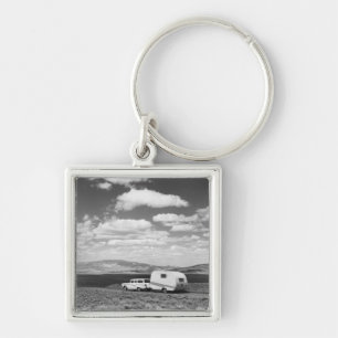 Car pulling trailer on road key ring