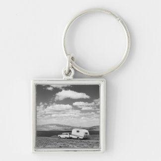 Car pulling trailer on road key ring