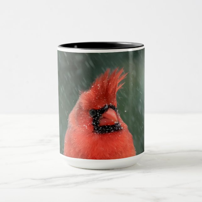 Cardinal in a pine tree during a snow storm mug (Center)