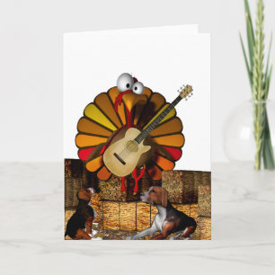 Cartoon turkey on hay with guitar and beagles holiday card