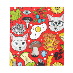 Cat and egg on red notepad