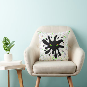 Cat Eyes looking out a Black Blob Cushion