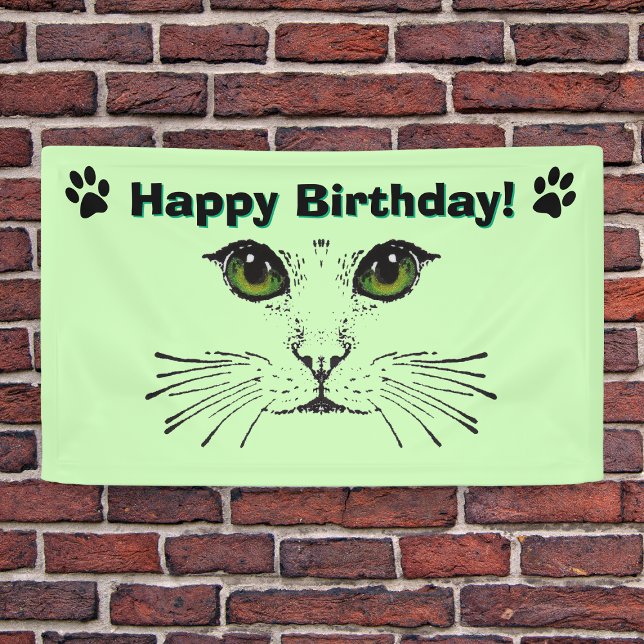 Cat Face Whiskers Green Eyes Paw Prints Birthday Banner (cat face drawing in black green eyes whiskers black cat paw prints on green birthday party backdrop.)