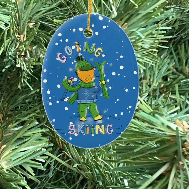 Cat going skiing Christmas ornament (Cat going skiing blue oval ceramic Christmas ornament .)