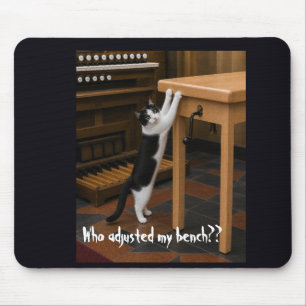 Cat scratching an organ bench mouse mat