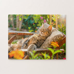 Cat sleeping in garden chair among flowers jigsaw puzzle