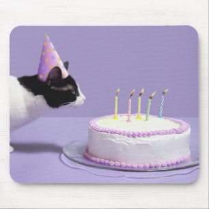 Cat wearing birthday hat blowing out candles mouse mat