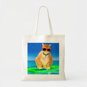 Cat with sunglasses surfing in the ocean tote bag